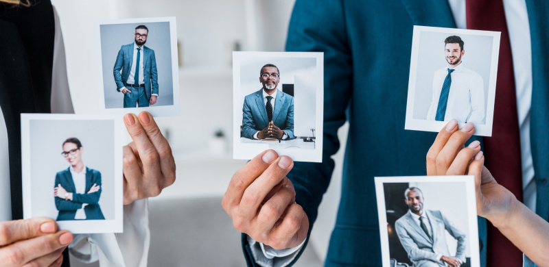 cropped view of recruiters touching photos